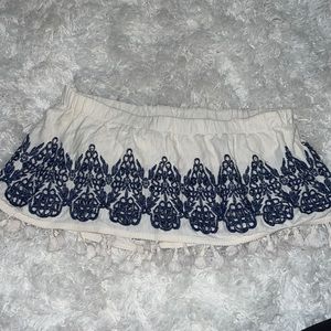 White, sleeveless, cream white colored top.